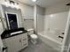 Bathroom featuring a vanity with black countertop and a shower-tub combination at 157 Powder Spring Dr, Statesville, NC 28677