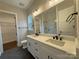 Bathroom featuring double sinks, a large mirror, and a tiled walk-in shower at 157 Powder Spring Dr, Statesville, NC 28677