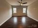 Bright bedroom with hardwood floors, two windows, and ample space for relaxation at 157 Powder Spring Dr, Statesville, NC 28677