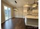 Bright dining area featuring hardwood floors, modern pendant lighting, and sliding door access to the outdoor deck at 157 Powder Spring Dr, Statesville, NC 28677