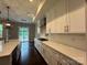 Bright, modern kitchen showcasing white cabinets, a gas cooktop, and a seamless flow to the breakfast nook at 157 Powder Spring Dr, Statesville, NC 28677
