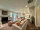 Open-concept living room featuring a fireplace, hardwood floors, and seamless flow into the dining and kitchen areas at 157 Powder Spring Dr, Statesville, NC 28677