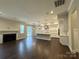 Open-concept room featuring a fireplace, hardwood floors, seamlessly flowing into the dining and kitchen at 157 Powder Spring Dr, Statesville, NC 28677