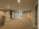Large loft space with neutral carpet, recessed lighting, and a view to the outside at 157 Powder Spring Dr, Statesville, NC 28677