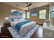 Bright staged bedroom featuring a ceiling fan, recessed lights, and scenic views from two windows at 157 Powder Spring Dr, Statesville, NC 28677