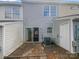 The backyard features gray vinyl siding, a sliding glass door and a patio with a rock garden at 16837 Greenlawn Hills Ct, Charlotte, NC 28213