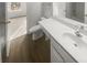 Clean bathroom featuring white vanity, commode, and combination tub and shower at 16837 Greenlawn Hills Ct, Charlotte, NC 28213