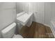 Bathroom featuring a toilet, single sink vanity, and large mirror at 16837 Greenlawn Hills Ct, Charlotte, NC 28213