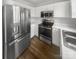 Shot of kitchen with stainless steel refrigerator, microwave and oven, and light countertops at 16837 Greenlawn Hills Ct, Charlotte, NC 28213