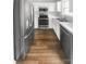 Updated kitchen featuring stainless steel appliances, white cabinets, and laminate floors at 16837 Greenlawn Hills Ct, Charlotte, NC 28213