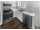 Close-up of kitchen features stainless steel oven, microwave, sink and faucet at 16837 Greenlawn Hills Ct, Charlotte, NC 28213
