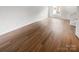 A bright, empty living room with laminate flooring, a door and a large window at 16837 Greenlawn Hills Ct, Charlotte, NC 28213