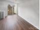 Bright living room featuring wood floors and sliding glass doors to a small outdoor patio at 16837 Greenlawn Hills Ct, Charlotte, NC 28213