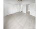 Spacious, empty main bedroom with three closets, neutral colors and ceiling fan at 16837 Greenlawn Hills Ct, Charlotte, NC 28213