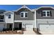 Charming townhome featuring a one-car garage, modern gray siding, and a well-manicured front yard at 1733 Braemar Village Dr, Monroe, NC 28110