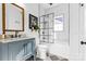 Elegant bathroom featuring a tub with black framed shower, marble countertop vanity, and decorative fixtures, offering a stylish retreat at 239 Euclid Ave, Statesville, NC 28677