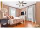 Cozy bedroom with hardwood floors, ceiling fan, natural light, and neutral tones, creating a tranquil and inviting space at 239 Euclid Ave, Statesville, NC 28677