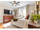 Bright bedroom featuring a four-poster bed, ceiling fan, hardwood floors, and modern decor, creating a cozy atmosphere at 239 Euclid Ave, Statesville, NC 28677