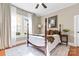 Tranquil bedroom with a four-poster bed, natural light, and an elegant rug at 239 Euclid Ave, Statesville, NC 28677