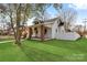 Quaint home with a covered porch, brick supports, and a well-manicured lawn at 239 Euclid Ave, Statesville, NC 28677