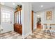 Hallway features checkerboard flooring, built-in wooden cabinet, and access to dining room at 239 Euclid Ave, Statesville, NC 28677