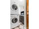 Convenient laundry area with stacked washer and dryer and gray cabinets, maximizing space and efficiency in a compact design at 239 Euclid Ave, Statesville, NC 28677
