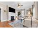 Cozy living room features a fireplace, mounted television, neutral furniture, and hardwood flooring at 239 Euclid Ave, Statesville, NC 28677