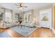 Inviting living room with neutral furniture, an elegant rug, a ceiling fan and natural light at 239 Euclid Ave, Statesville, NC 28677