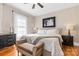 Comfortable bedroom with a cozy bed, stylish decor, and hardwood floors at 239 Euclid Ave, Statesville, NC 28677