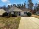 Charming single-story home with well-maintained landscaping and a concrete driveway at 2625 Westerwood Village Dr, Charlotte, NC 28214