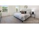 Bright and inviting bedroom with plush carpeting, a well-lit ambiance, and comfortable furnishings, perfect for relaxation at 265 Red Fox Ln # 1P, China Grove, NC 28023