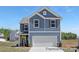 Charming new construction home with blue siding, white trim, and a two-car garage, nestled in a desirable neighborhood at 265 Red Fox Ln # 1P, China Grove, NC 28023