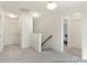 Upstairs hallway with carpet, providing access to bedrooms and bathrooms at 265 Red Fox Ln # 1P, China Grove, NC 28023