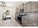 Modern kitchen featuring stainless steel appliances, granite countertops, and ample cabinet space, perfect for cooking and entertaining at 265 Red Fox Ln # 1P, China Grove, NC 28023