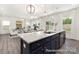 Gourmet kitchen with an island, granite countertops, modern appliances, and stylish lighting, ideal for culinary enthusiasts at 265 Red Fox Ln # 1P, China Grove, NC 28023