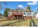 Home's backyard features a wooden deck, fence and brick foundation at 304 Keller St, China Grove, NC 28023