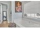 Bathroom with large soaking tub, privacy window, and decorative art at 304 Keller St, China Grove, NC 28023