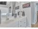 Bright bathroom featuring double vanity sinks, white cabinets, and a decorative mirror at 304 Keller St, China Grove, NC 28023