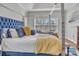 Bedroom with large bed featuring blue velvet headboard, accent pillows, and a throw blanket at 304 Keller St, China Grove, NC 28023