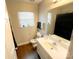 Clean bathroom featuring a well-lit vanity, a large mirror, and ample counter space at 312 Radio Rd, Charlotte, NC 28216