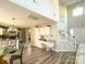 Bright living area with hardwood floors, staircase, and a view of the kitchen at 312 Radio Rd, Charlotte, NC 28216