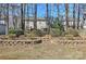 Landscaped backyard featuring a two-story home viewed through trees and greenery at 3620 Cole Mill Rd, Charlotte, NC 28270