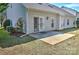 Rear of house with a small patio and well-maintained landscaping at 3620 Cole Mill Rd, Charlotte, NC 28270