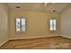 Bright bedroom features wood floors, plantation shutters and neutral walls at 3620 Cole Mill Rd, Charlotte, NC 28270