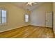 Bright bedroom features wood floors, plantation shutters and a ceiling fan at 3620 Cole Mill Rd, Charlotte, NC 28270