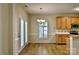 A dining room features a wood floor, bright windows, and wooden cabinets at 3620 Cole Mill Rd, Charlotte, NC 28270