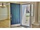 Inviting entryway featuring a blue front door, hardwood floors, and a view of the living space at 3620 Cole Mill Rd, Charlotte, NC 28270