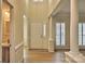 Bright foyer with hardwood floors, white trim, and a glimpse of the living area at 3620 Cole Mill Rd, Charlotte, NC 28270