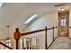 Hallway featuring a skylight, carpet flooring, and banister overlooking living area at 3620 Cole Mill Rd, Charlotte, NC 28270