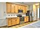 A well-equipped kitchen boasts stainless steel appliances, wood cabinets, and ample counter space at 3620 Cole Mill Rd, Charlotte, NC 28270